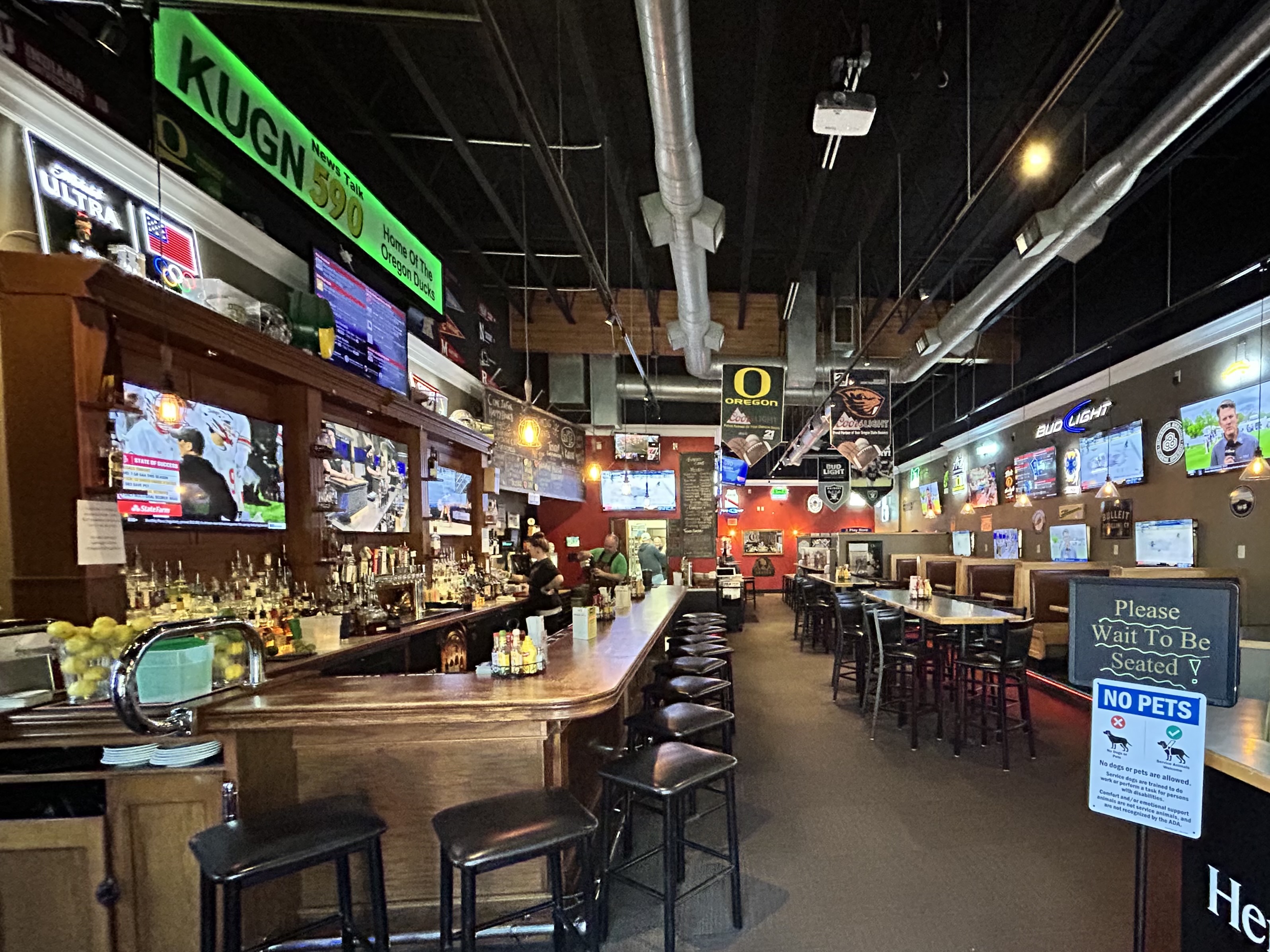 The bar and screens inside SideBar Eugene